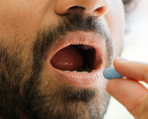 A South Asian gay man takes a PrEP pill to prevent HIV